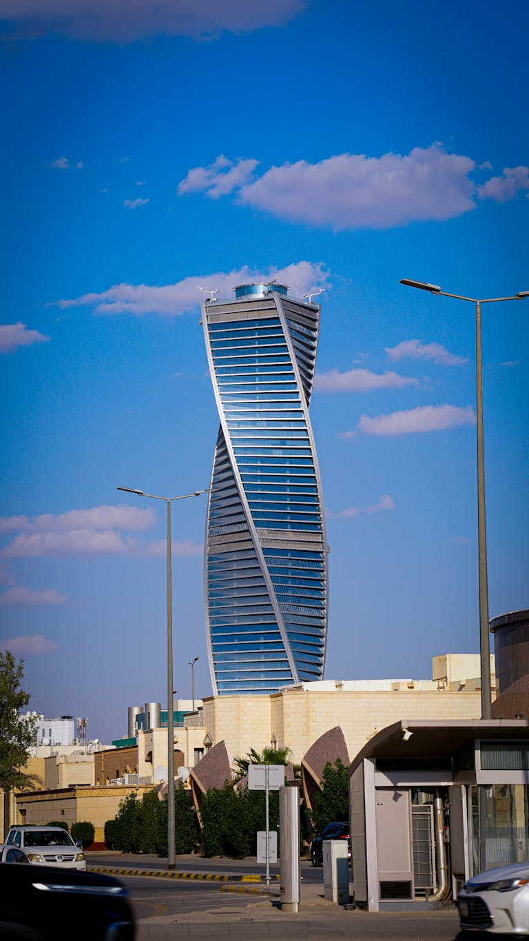 Architectural landmark, the twisted tower in Riyadh against a blue sky.